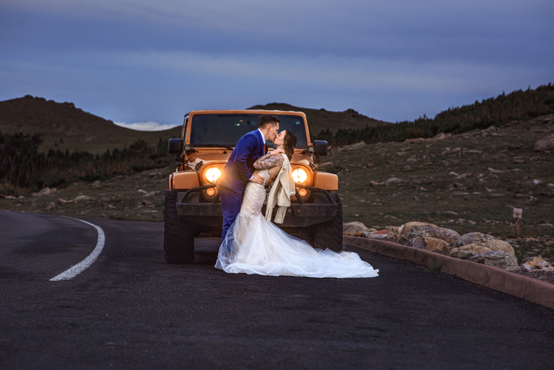 Elopement Photographer, grooming dipping bride in front of their jeep