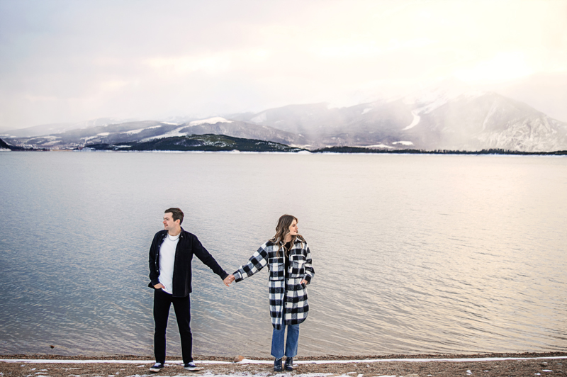 Wedding and Elopement Photographer, couple standing next to large body of water holding hands