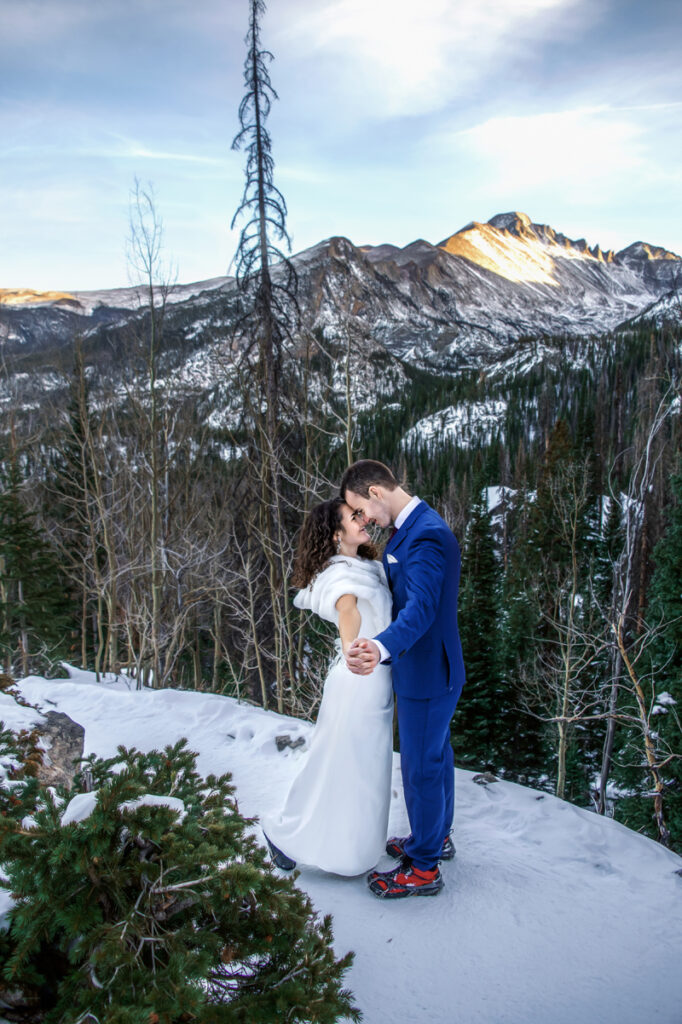 Wedding and Elopement Photographer, bride and groom standing out in the snow