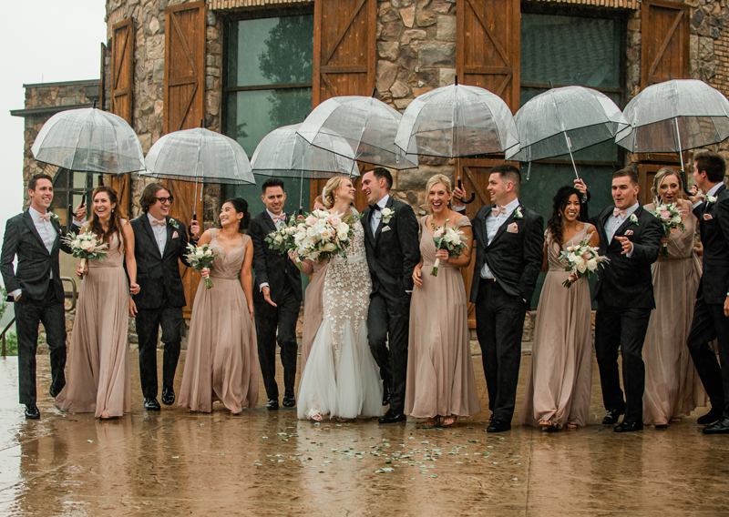 Wedding and Elopement Photographer, bridal party standing outside in the rain with umbrellas