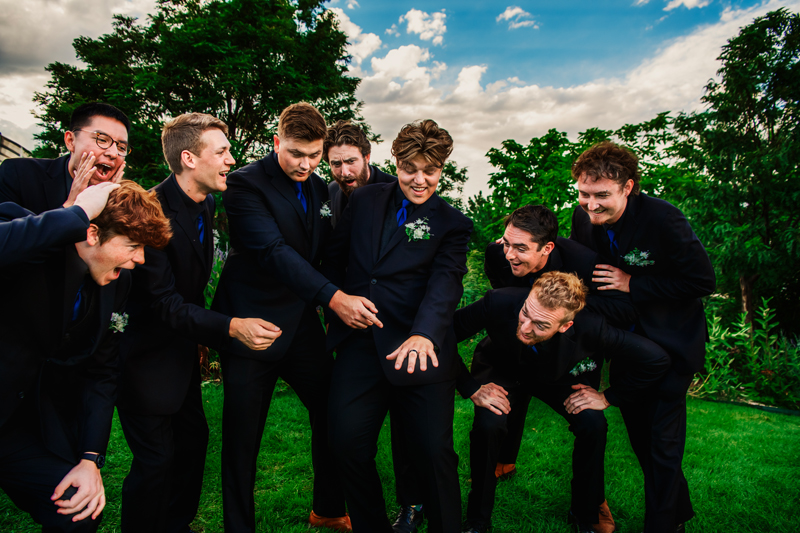 Wedding and Elopement Photography, groomsmen huddled together laughing
